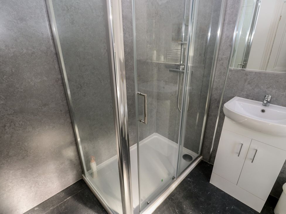 A bathroom with a shower and sink at 27 Calton terrace Skipton