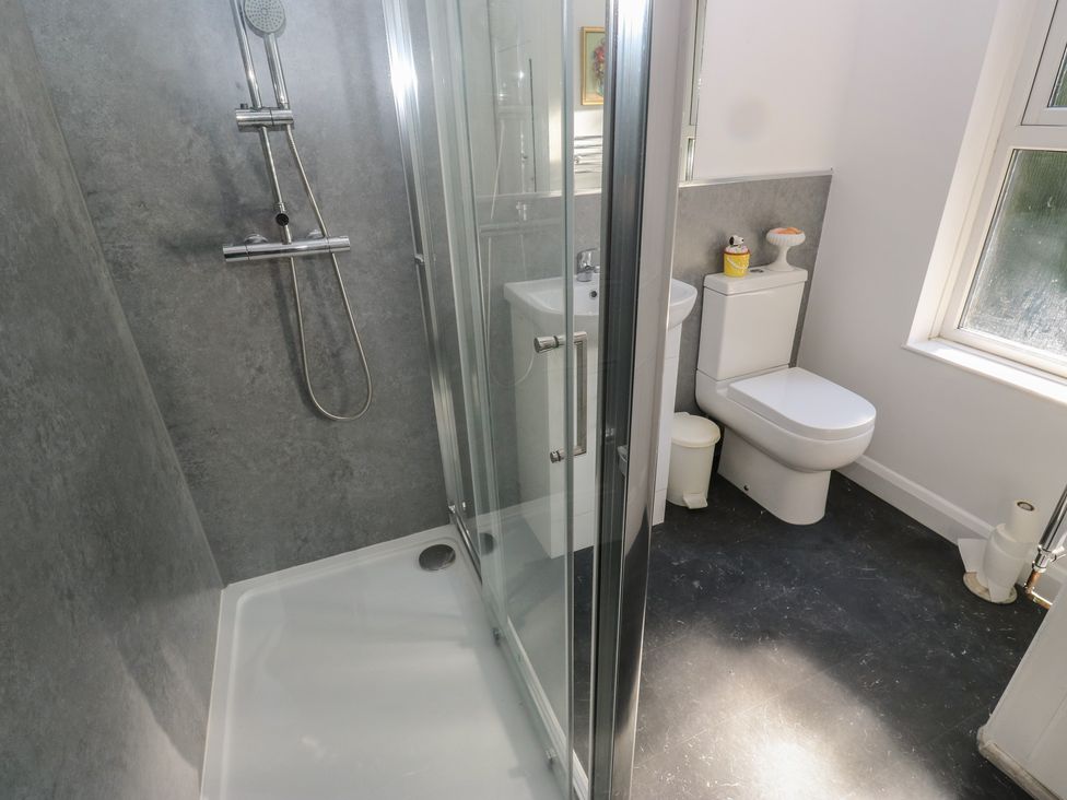 A bathroom with a shower, toilet, and sink at 27 Calton terrace Skipton