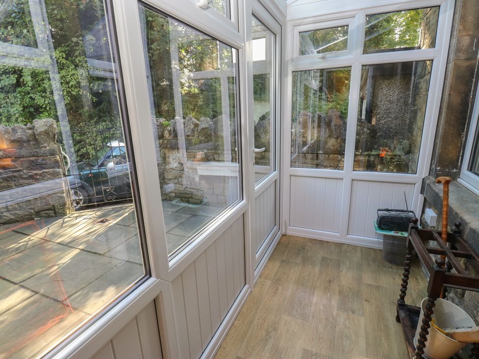 A conservatory with glass windows and doors at 27 Calton terrace, Skipton