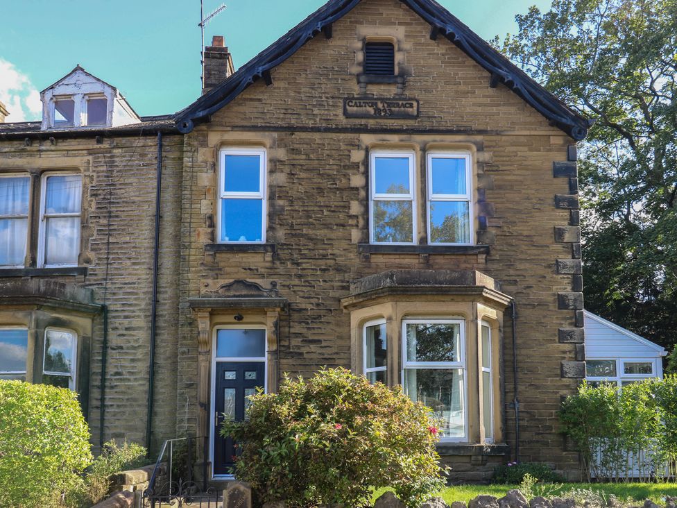 A house with multiple windows and a front door at 27 Calton Terrace Skipton