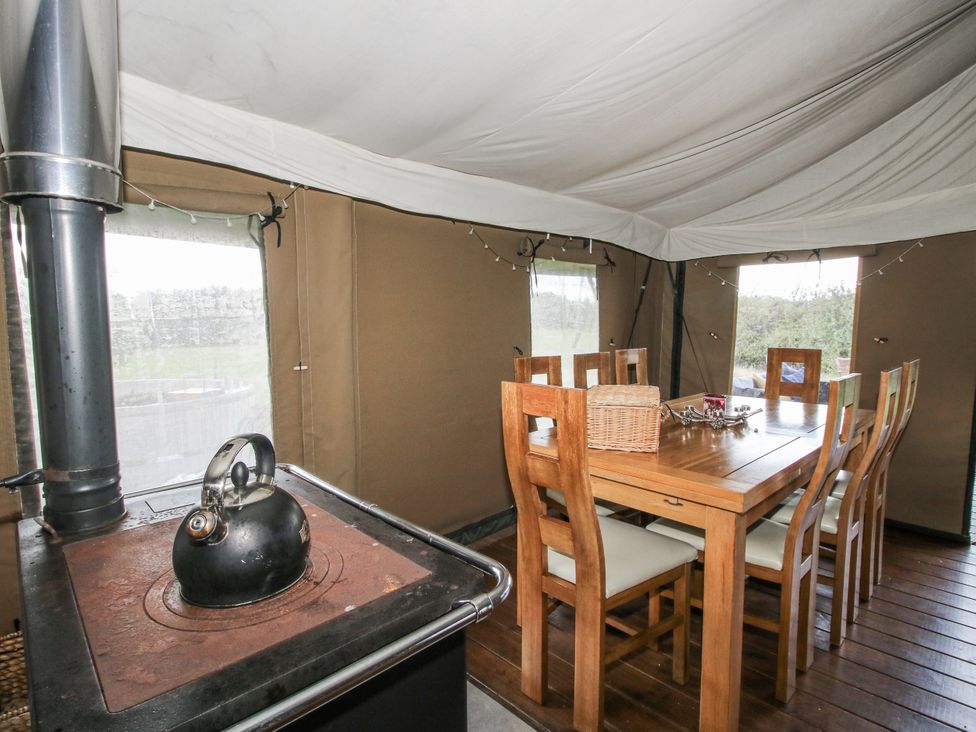 A dining area with a wooden table and kettle at Pear Trees in Bewdley