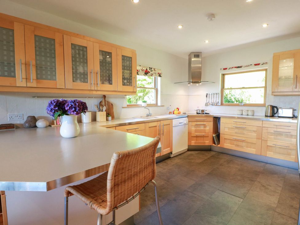 A kitchen with wooden cabinets and a countertop at Deer’s Leap