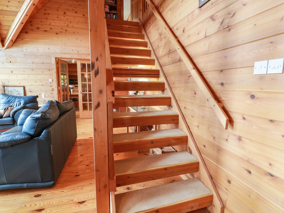 A living room with stairs and a sofa at Deer’s Leap