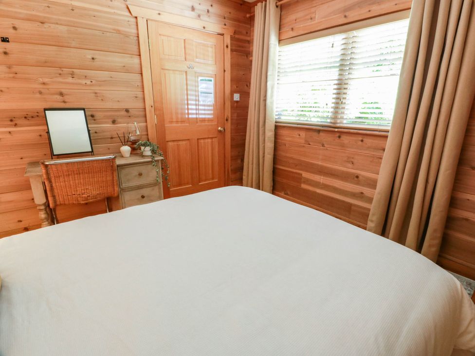 A bedroom with a bed and a dresser at Deer’s Leap