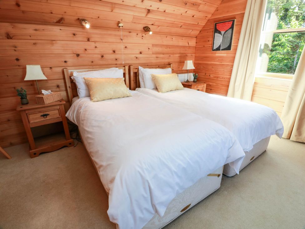 A bedroom with two beds and nightstands at Deer’s Leap