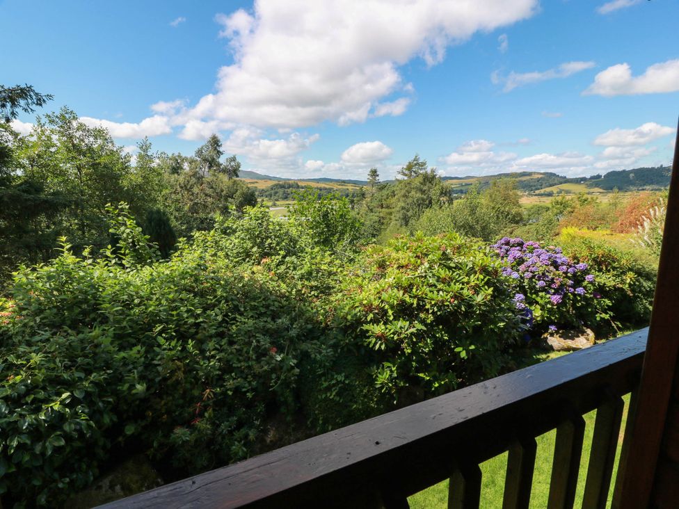 A view of trees and flowers from a balcony at Deer’s Leap