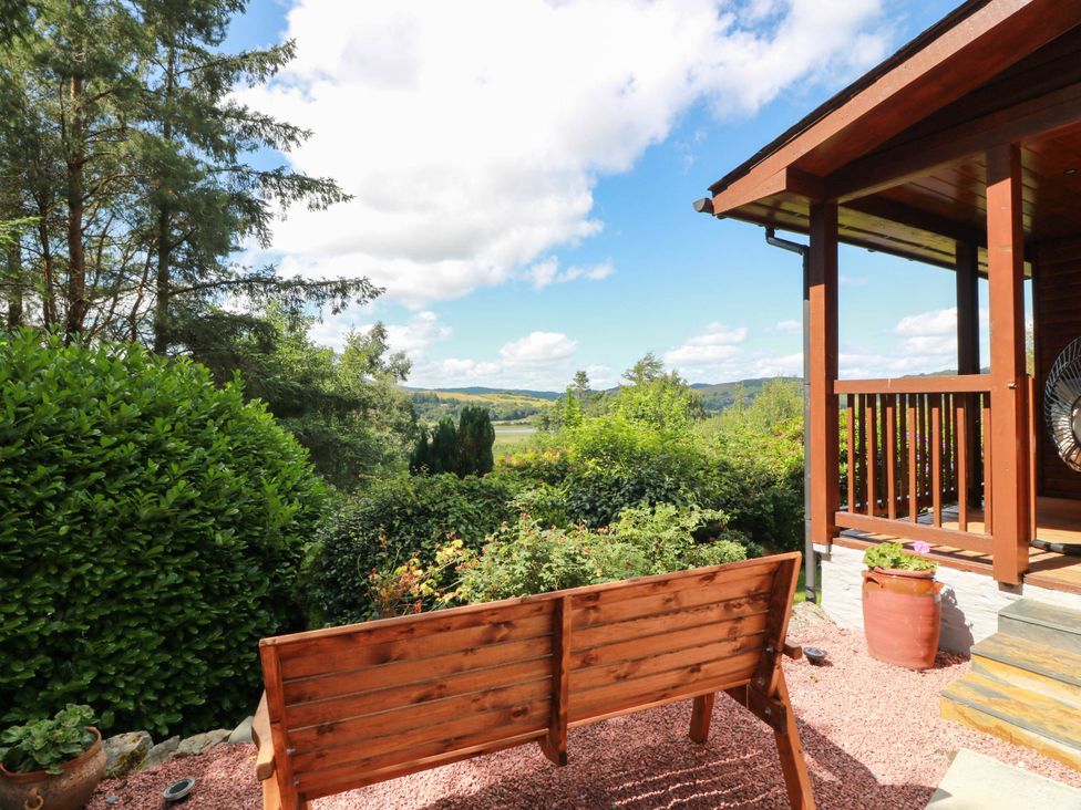 A garden with a wooden bench and greenery at Deer’s Leap in 