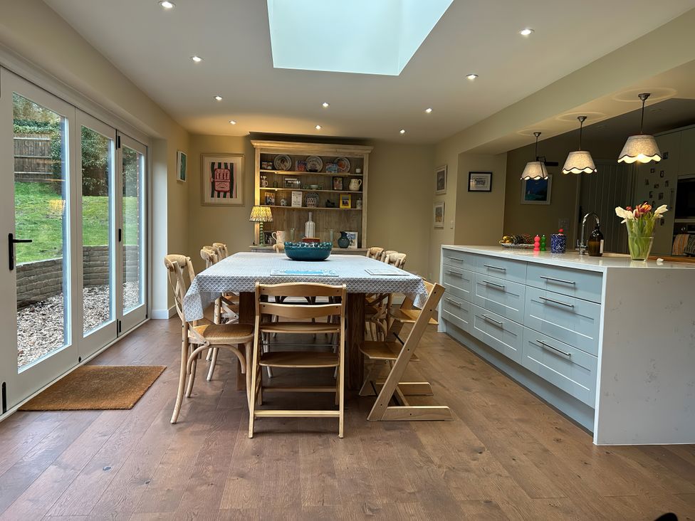 A dining room with a table and chairs at Riverside Cottage 