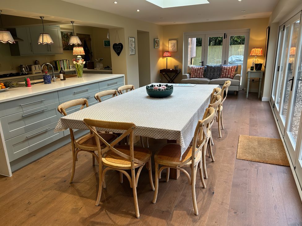 A dining area with a table and chairs at Riverside Cottage