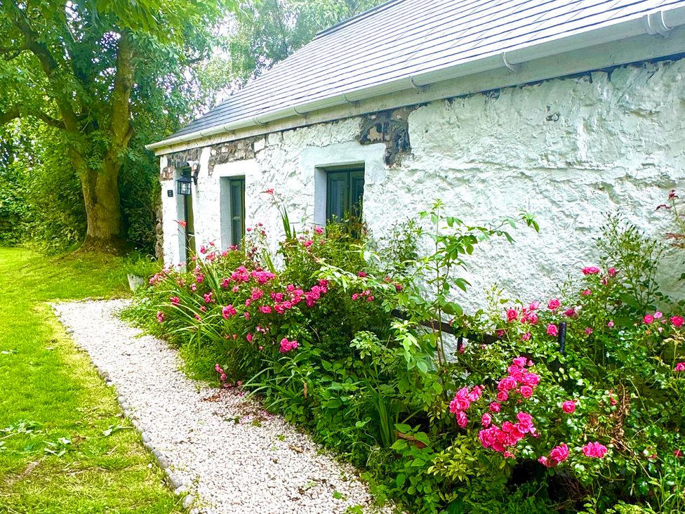 A cottage with a garden and pathway at Auld Cider Makers Cottage, Portstewart, County Londonderry