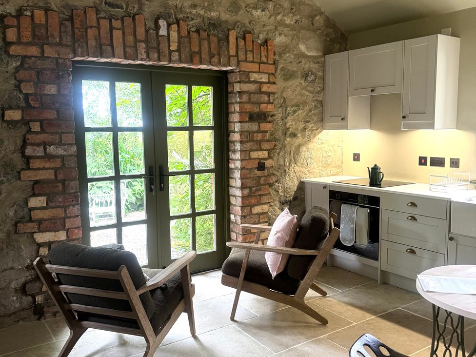 A kitchen with a view of the garden at Auld Cider Makers Cottage in Portstewart, County Londonderry