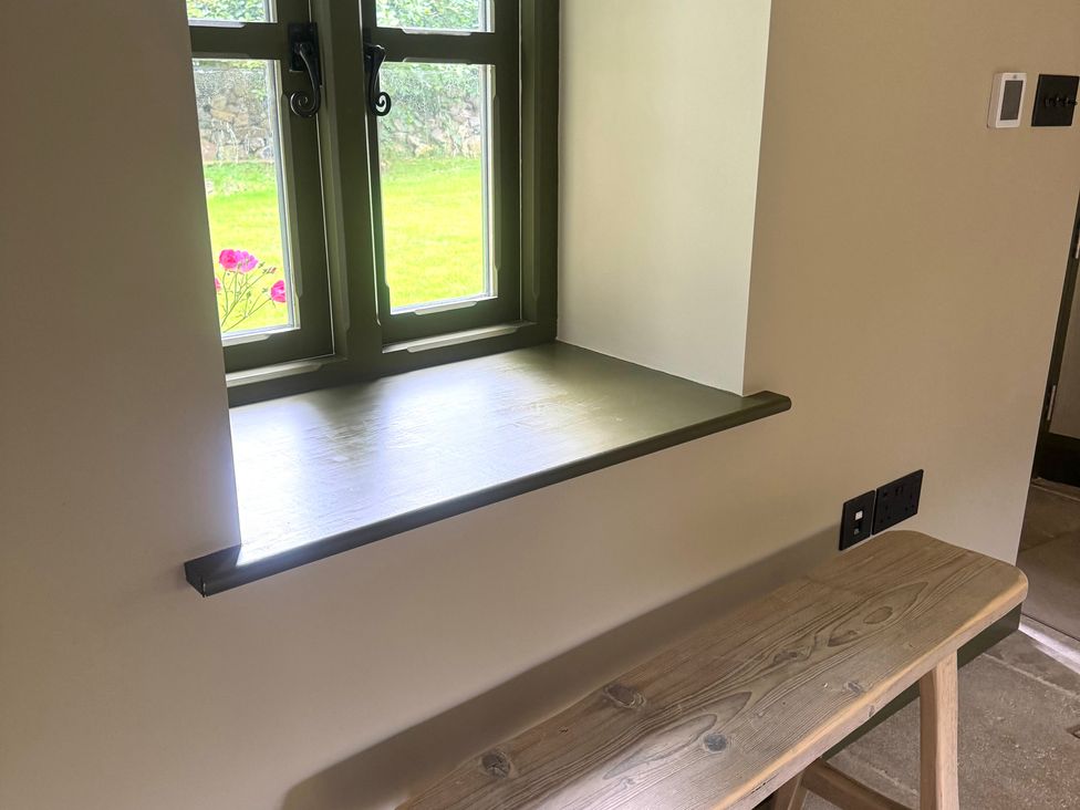 A window with a bench and electrical outlet at Auld Cider Makers Cottage, Portstewart, County Londonderry