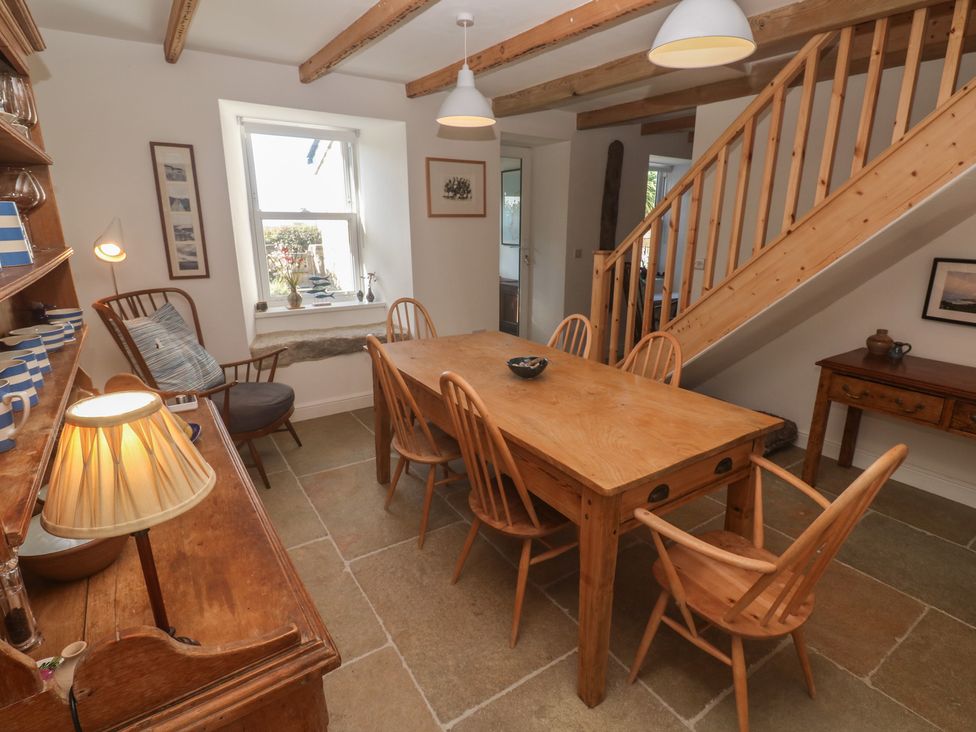 A dining room with a table and chairs at 12 Boswedden Terrace in St Just