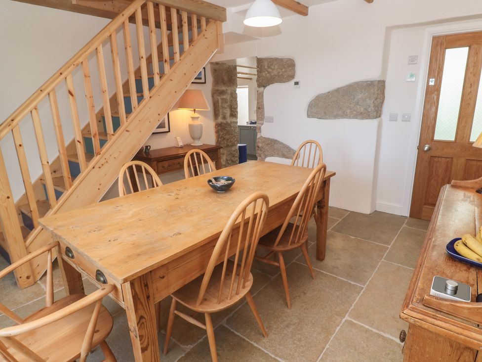 A dining room with a table and chairs at 12 Boswedden Terrace St Just
