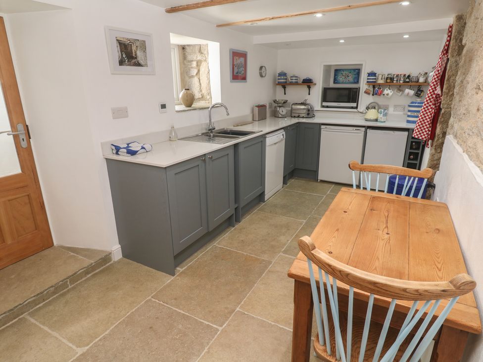 A kitchen with cabinets and appliances at 12 Boswedden Terrace in St Just