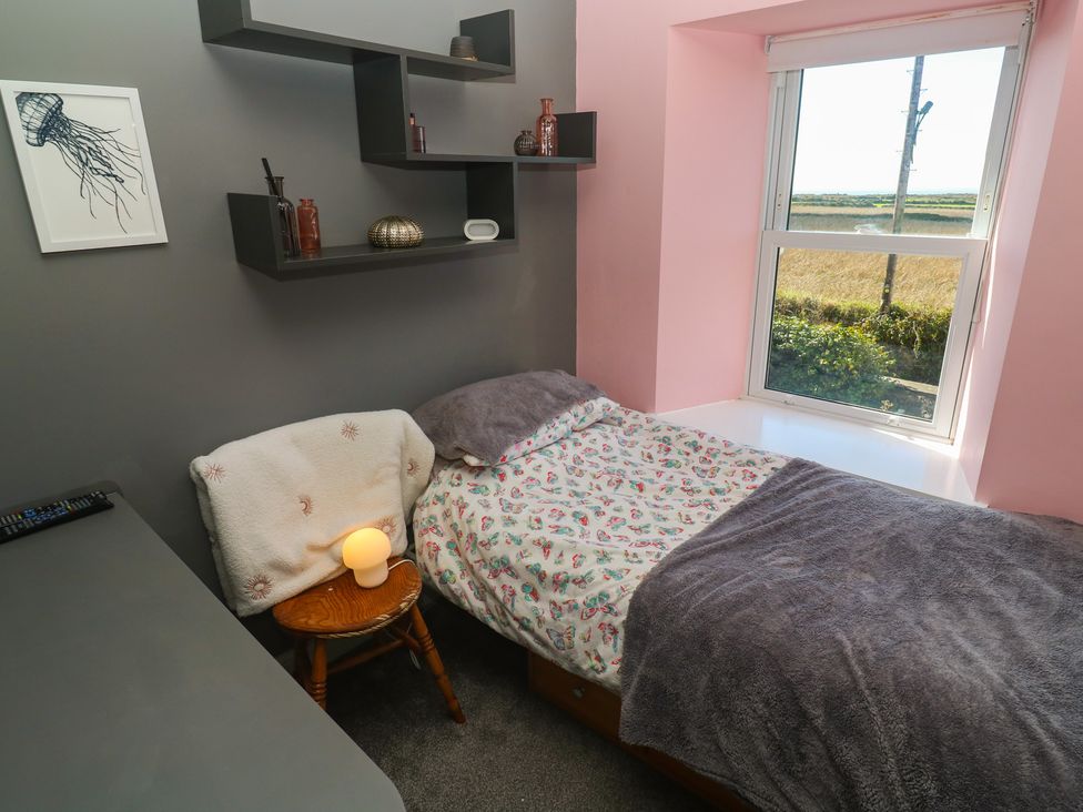 A bedroom with a bed and a shelf at 12 Boswedden Terrace St Just