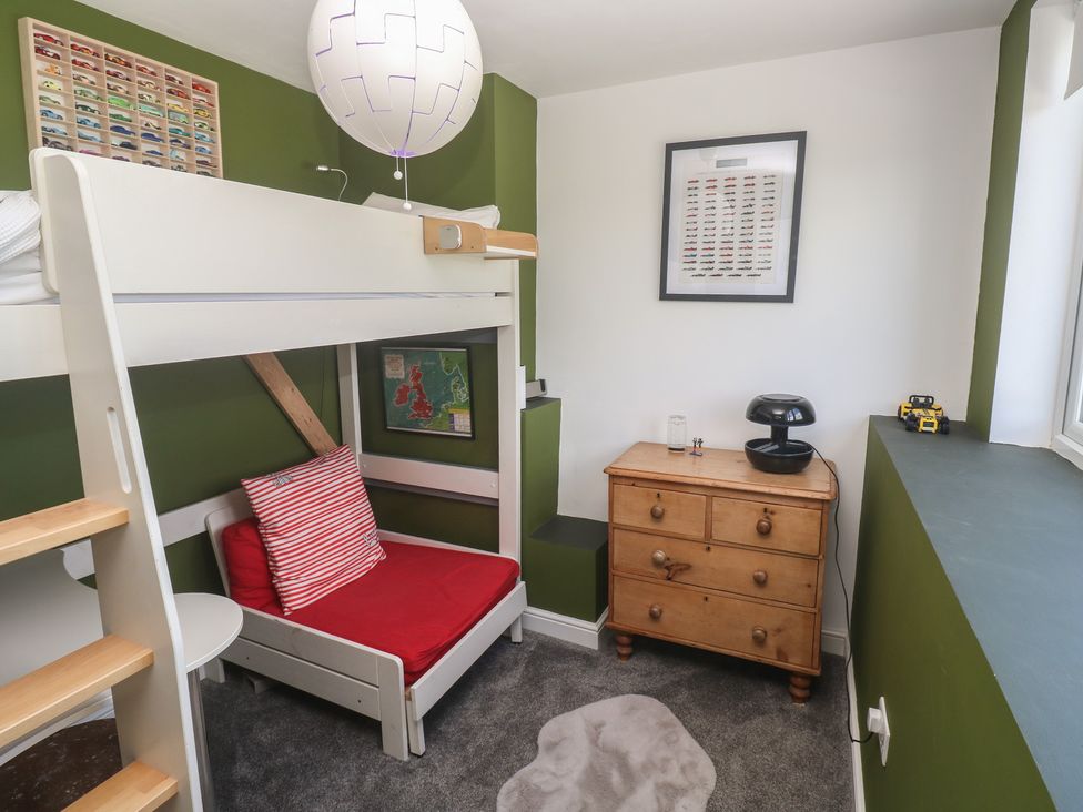 A bedroom with a loft bed and toy car at 12 Boswedden Terrace St Just
