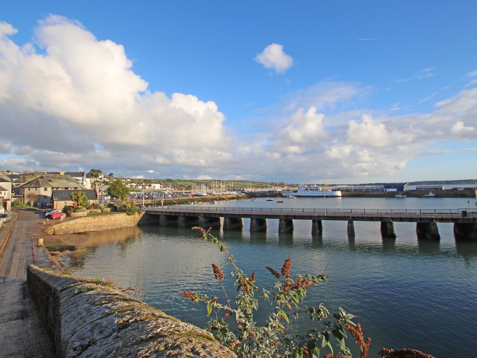 A view of a harbor with a bridge and boats at 12 Boswedden Terrace St Just