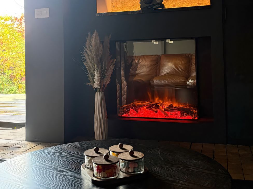 A living room featuring a fireplace and decorative items at Manor Farm House in Merton near Bicester