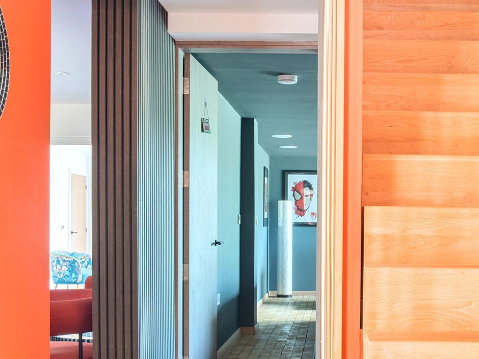 A hallway with a staircase and doors at Manor Farm House in Merton near Bicester