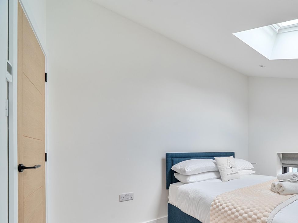 A bedroom with a bed and a door at Manor Farm House in Merton near Bicester