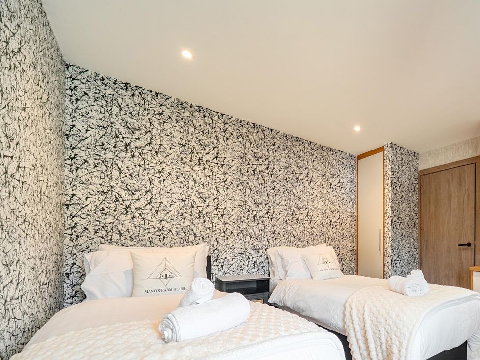 A bedroom with two beds at Manor Farm House in Merton near Bicester