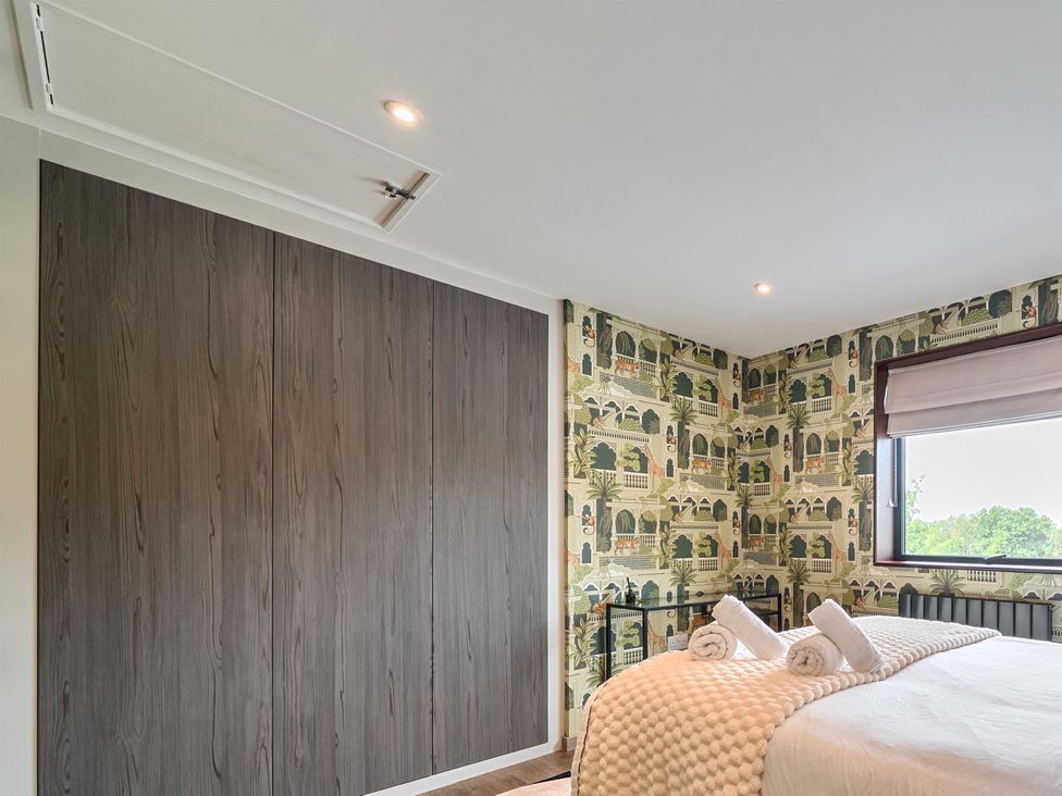 A bedroom with a bed and towels at Manor Farm House in Merton near Bicester