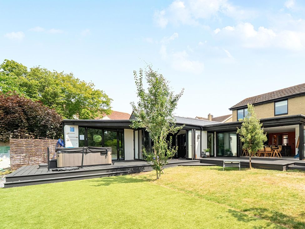 An outdoor space with a hot tub and garden at Manor Farm House in Merton near Bicester