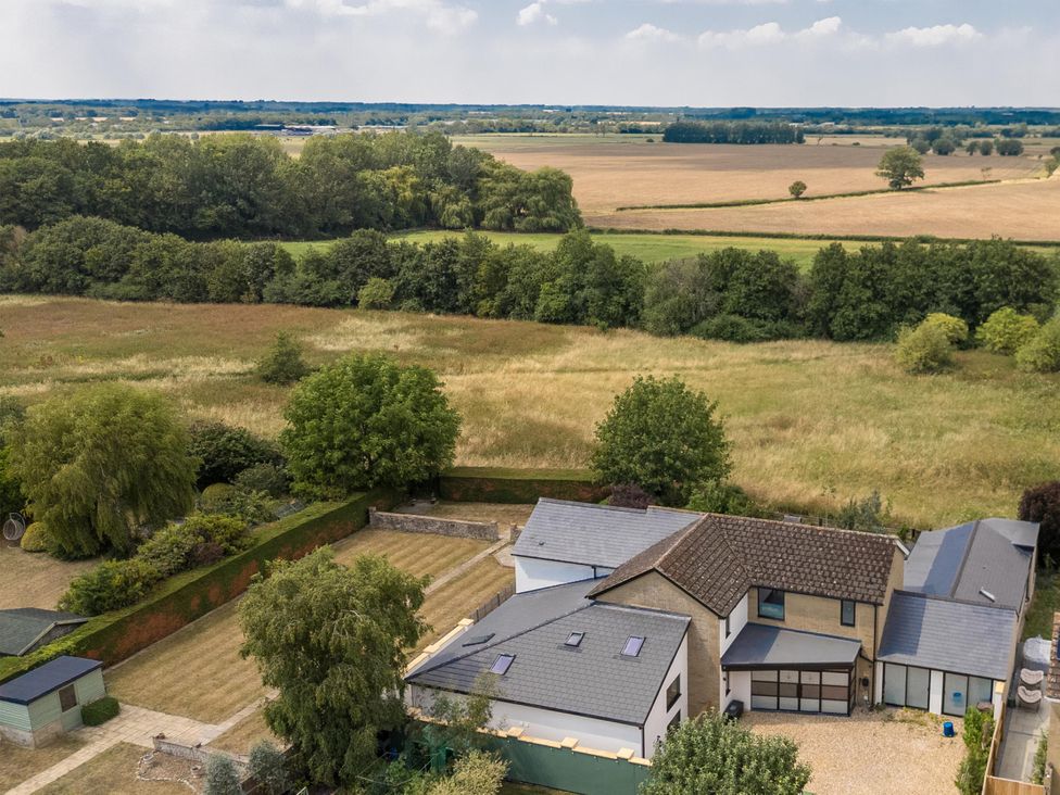 An aerial view of a house surrounded by gardens and fields at Manor Farm House in Merton near Bicester