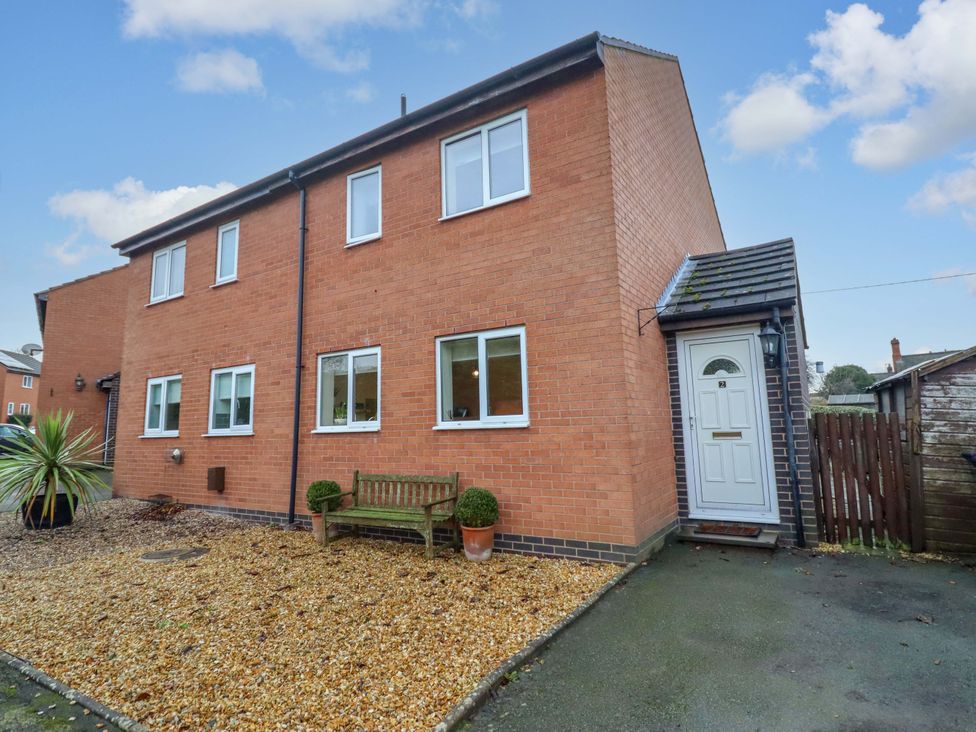 A house exterior with a bench and plants at 2 Horseshoe Road in Montgomery