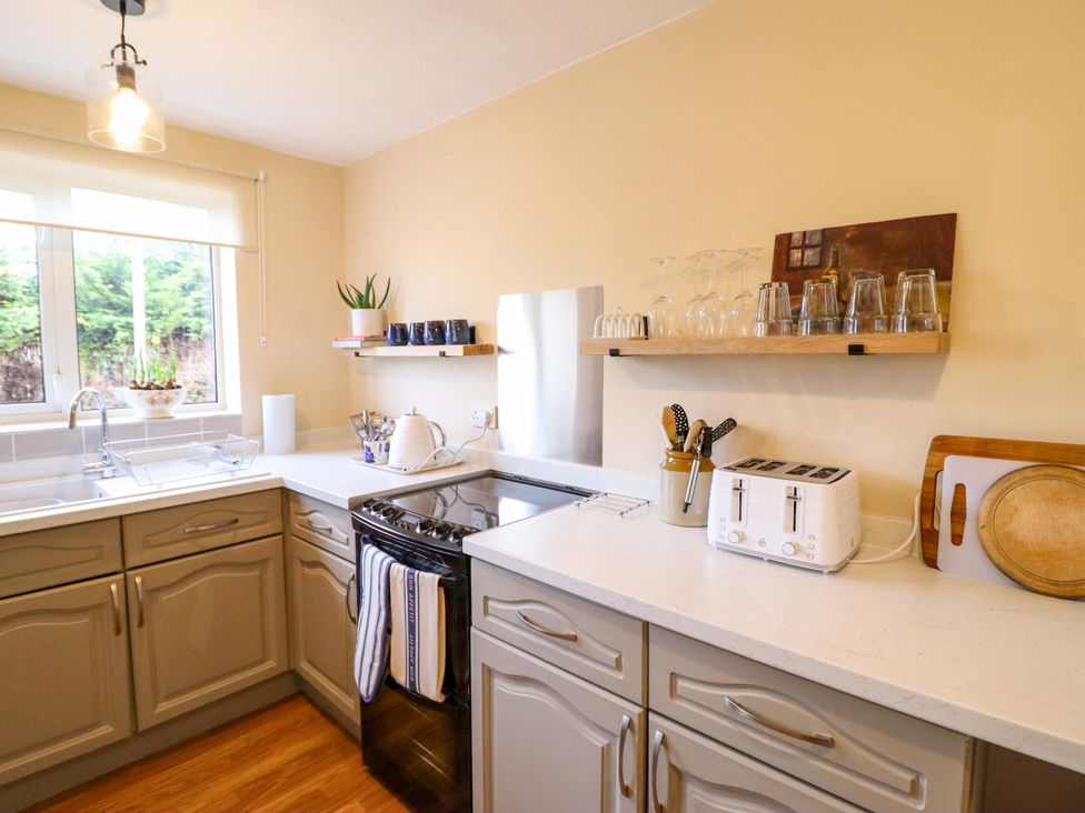 A kitchen with sink, stove, and window at 2 Horseshoe Road Montgomery