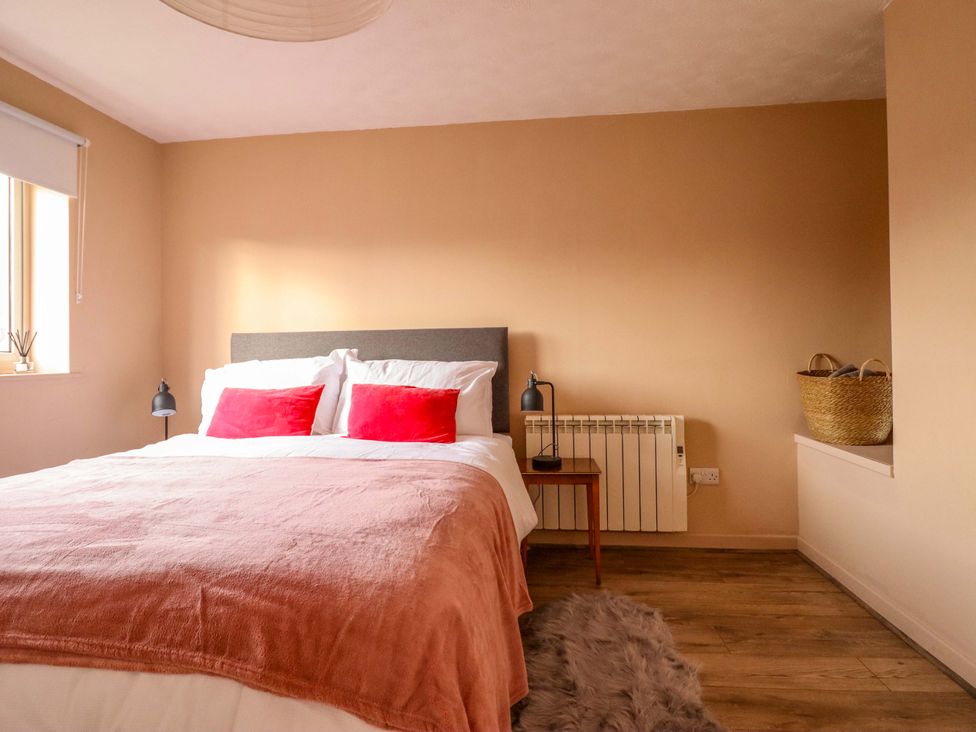A bedroom with a bed and bedside lamp at 2 Horseshoe Road in Montgomery