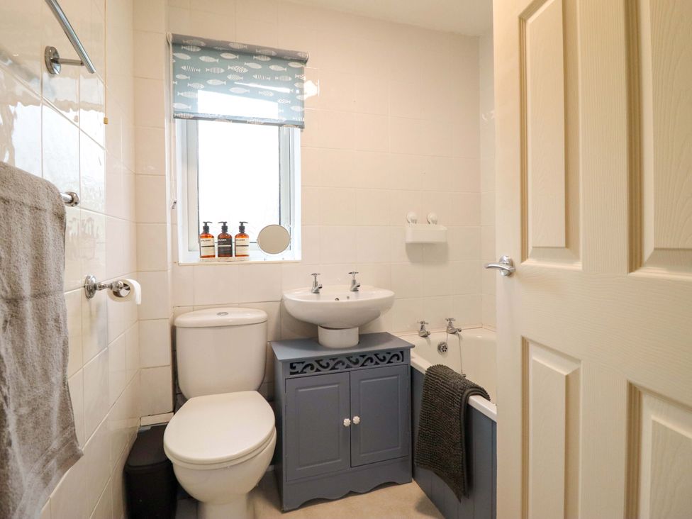 A bathroom with a toilet, wash basin, and bathtub at 2 Horseshoe Road Montgomery
