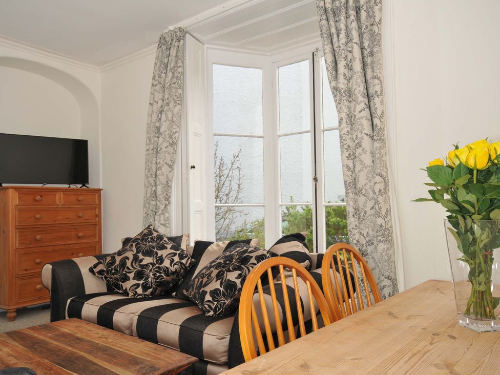 A living room with a sofa and television at Violet's Rest in Exeter