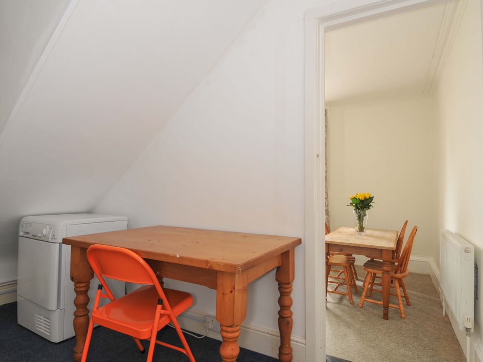 A dining area with a table and chairs at Violet's Rest in Exeter