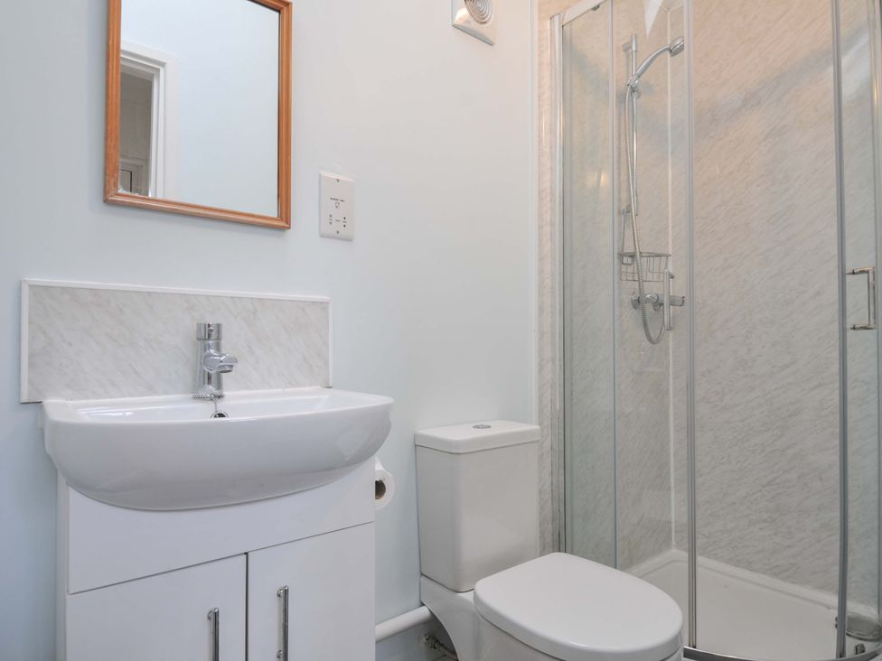 A bathroom with a sink, toilet, and shower at Violet's Rest in Exeter