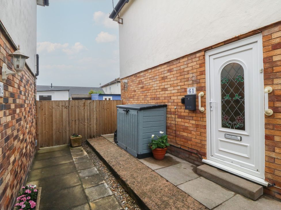 An outdoor area with a door and a shed at 61 Lloyd Street West in Llandudno
