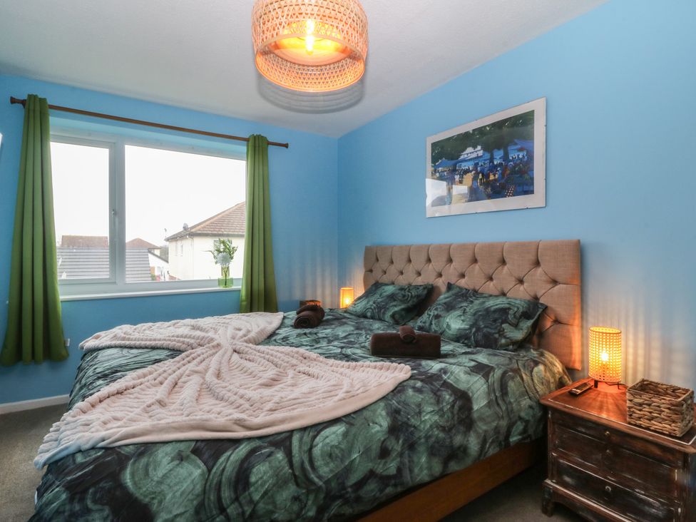 A bedroom with a bed and nightstand at 61 Lloyd Street West in Llandudno
