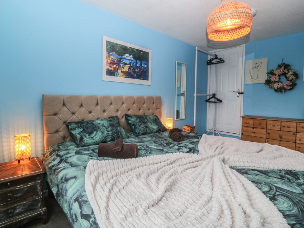 A bedroom with a bed and wardrobe at 61 Lloyd Street West in Llandudno