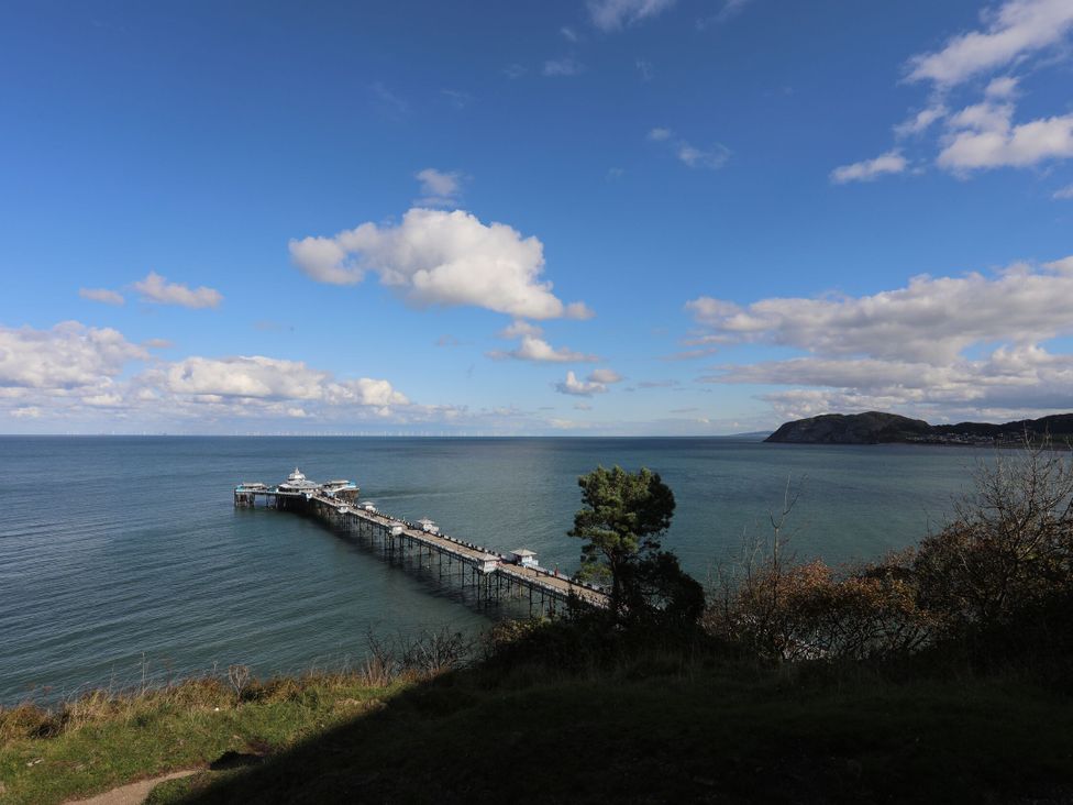 A pier extending into the sea at 61 Lloyd Street West Llandudno