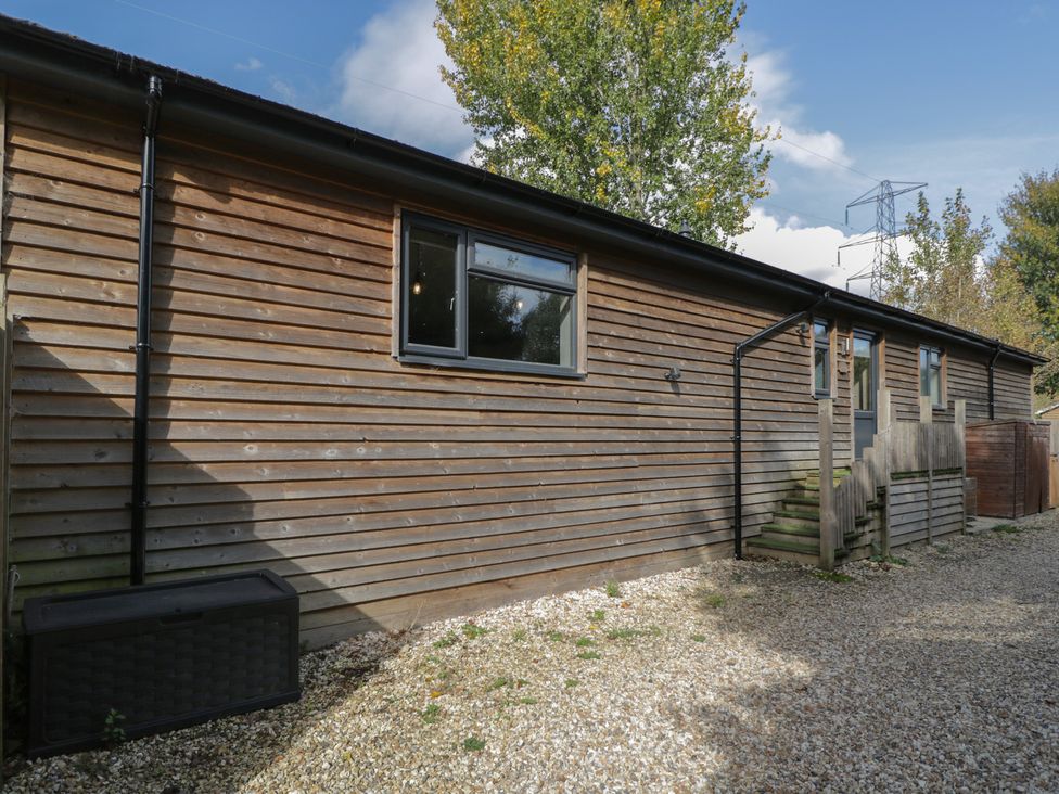 A building exterior with windows and a staircase at Willow Cottage in Whiteparish