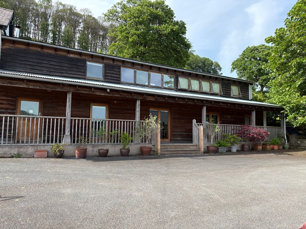 A wooden building with windows and porch at Cottage 2 in 