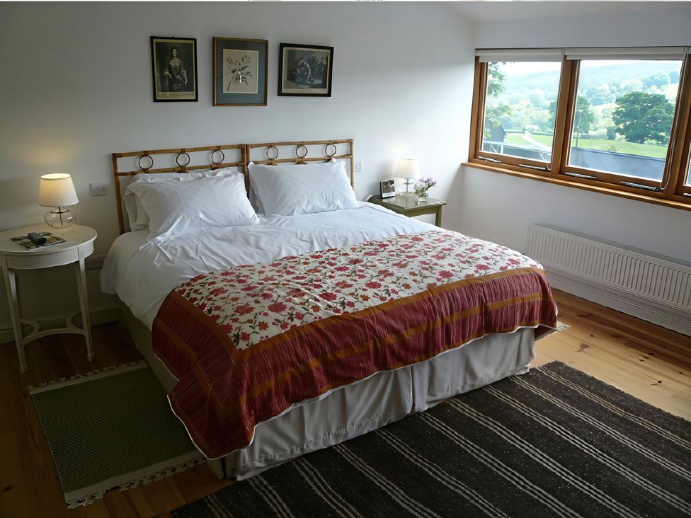 A bedroom with a bed and lamps at Cottage 2 