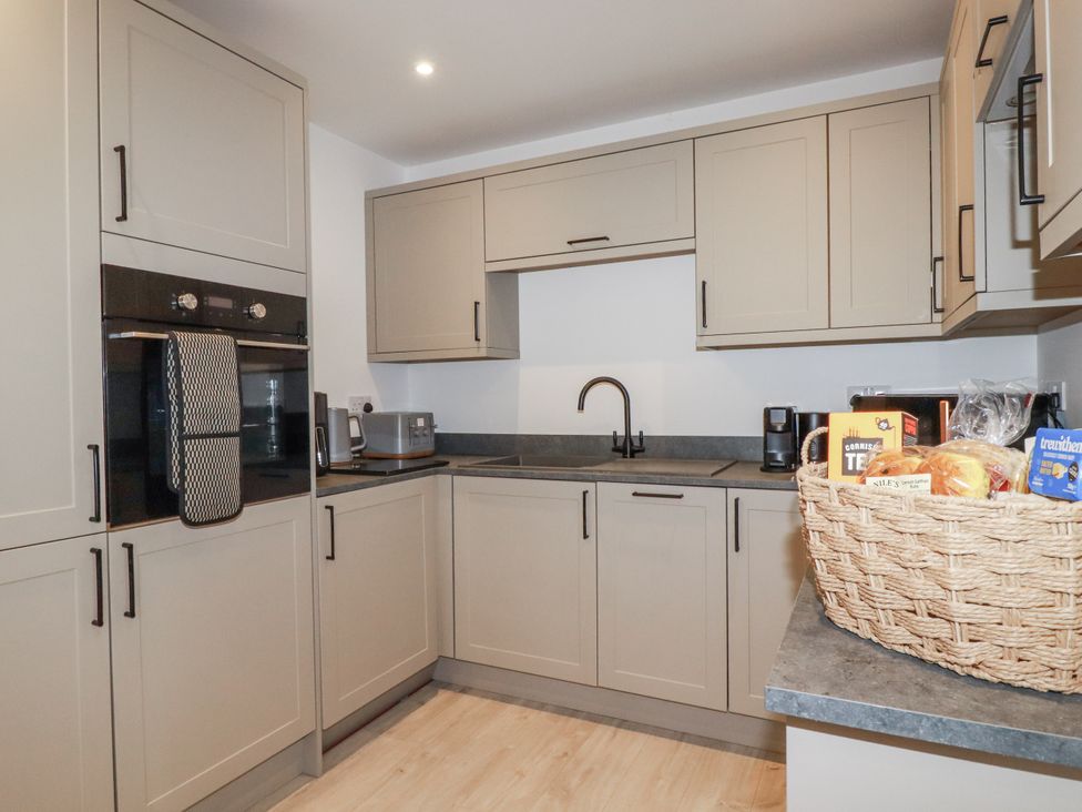 A kitchen with kitchen cabinets and appliances at Barn 2