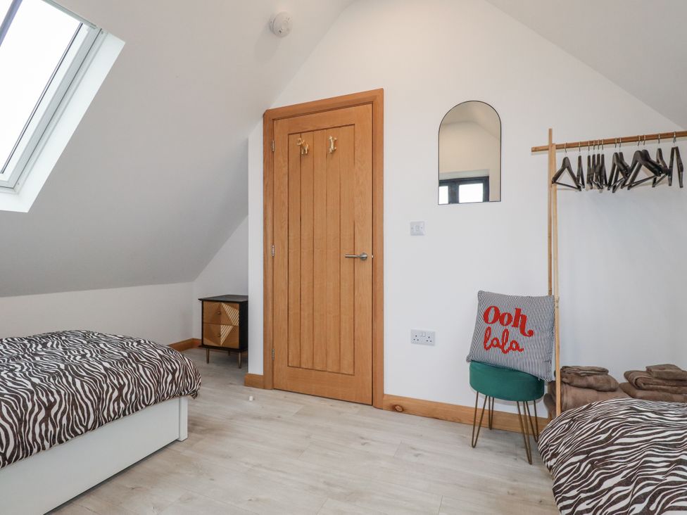 A bedroom with two beds and a door at Barn 2 in 