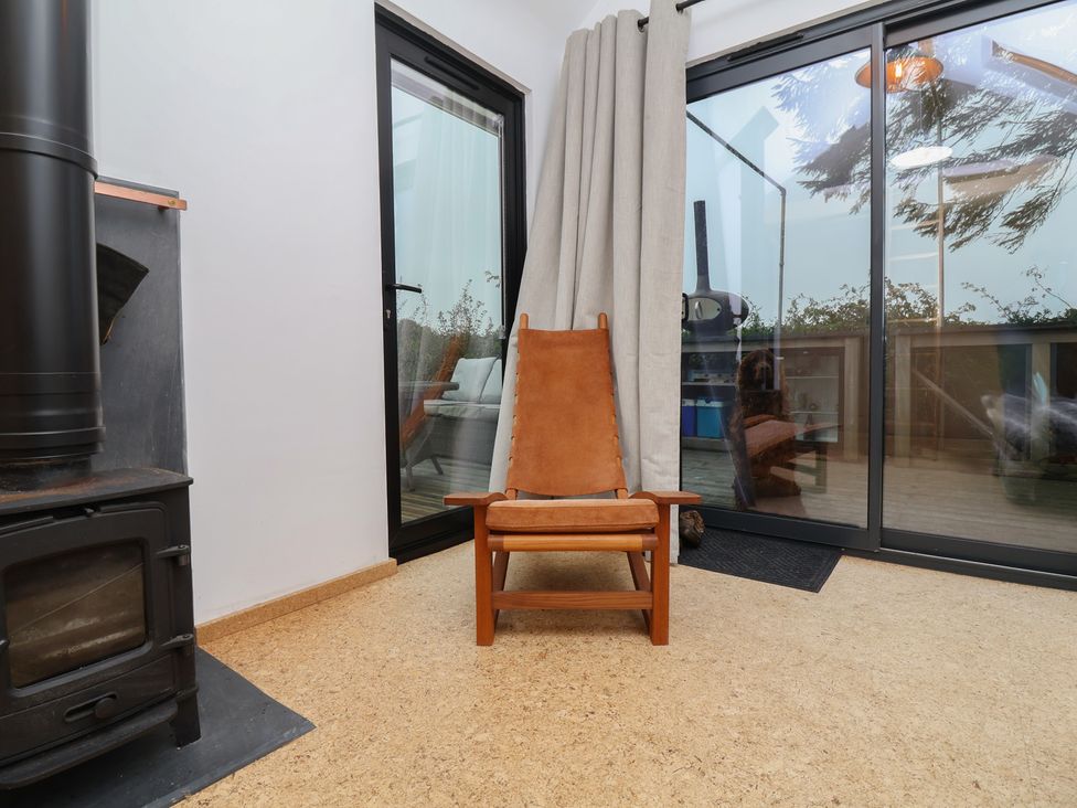 A snug with a chair and a stove at The Bothy in 
