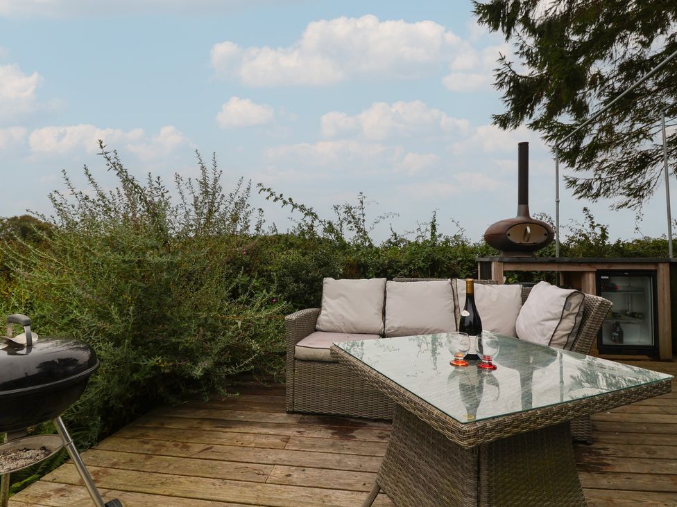 An outdoor lounge area with a couch and table at The Bothy