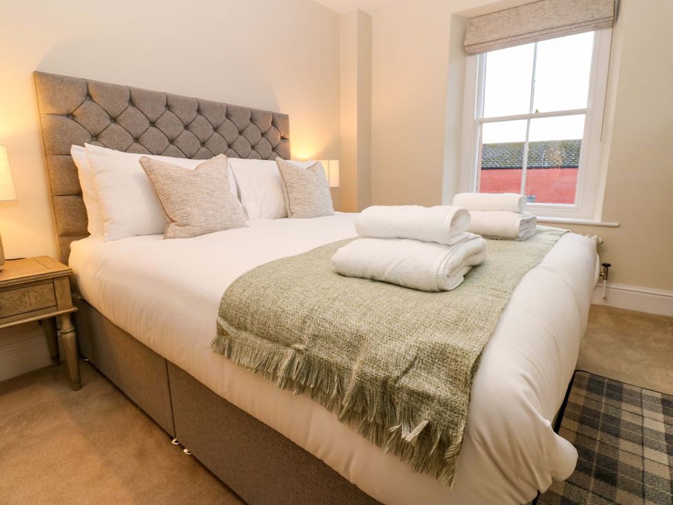 A bedroom with a bed and towels on the bed at Milford in Great Corby, Wetheral