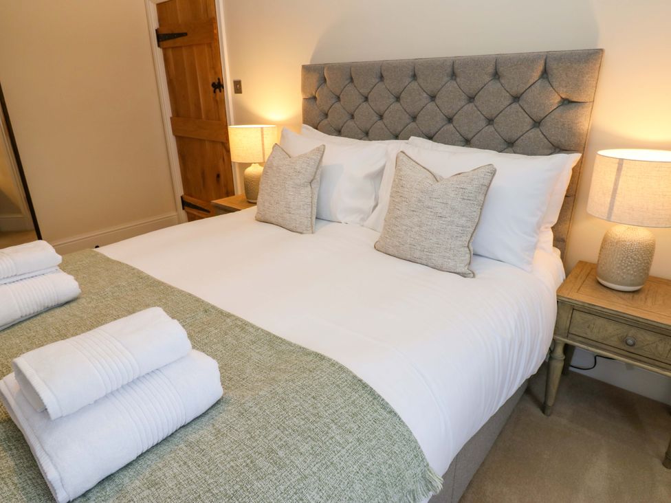A bedroom with a double bed and bedside tables at Milford in Great Corby, Wetheral