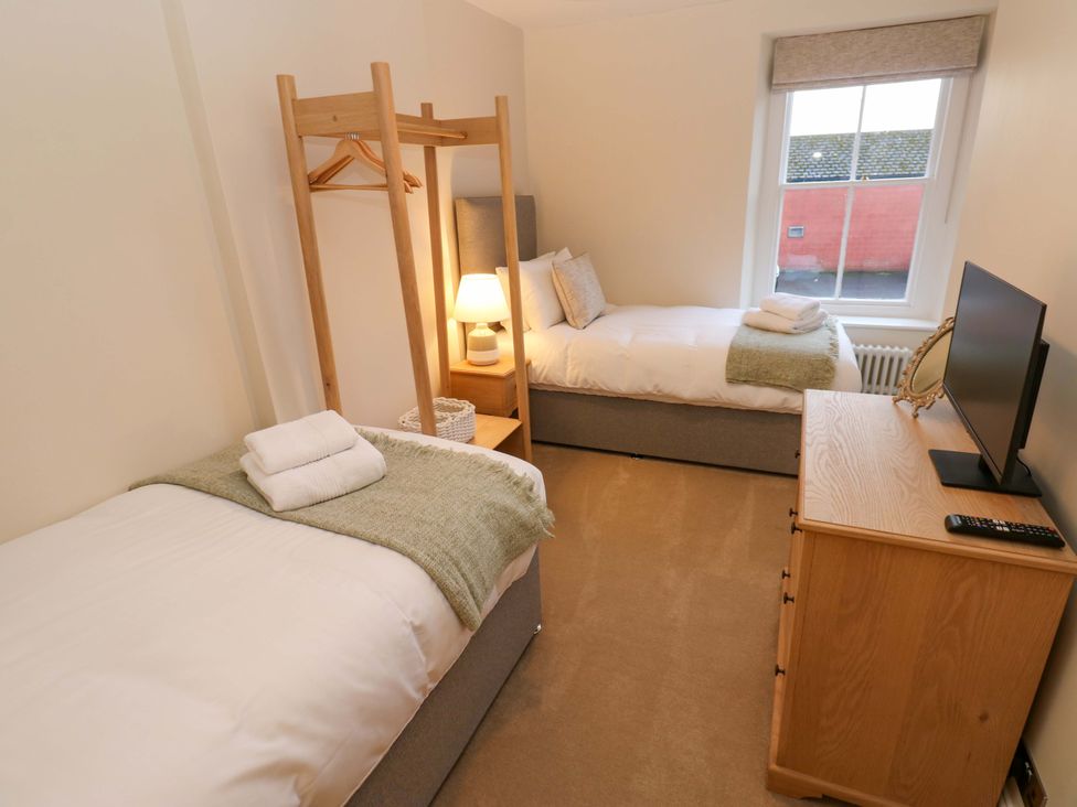 A bedroom with two beds and a television at Milford in Great Corby, Wetheral